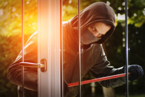 burglar prying open a door